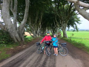 Couple with bikes at the Dark Hedges Causeway Coast self-guided bike tour with Ireland by Bike