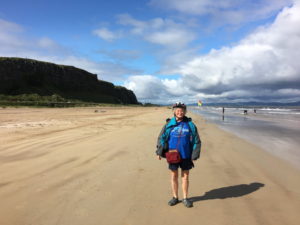 Cyclist standing on Downhill Beach on Causeway Coast cycling vacation with Ireland by Bike cycling and walking tours