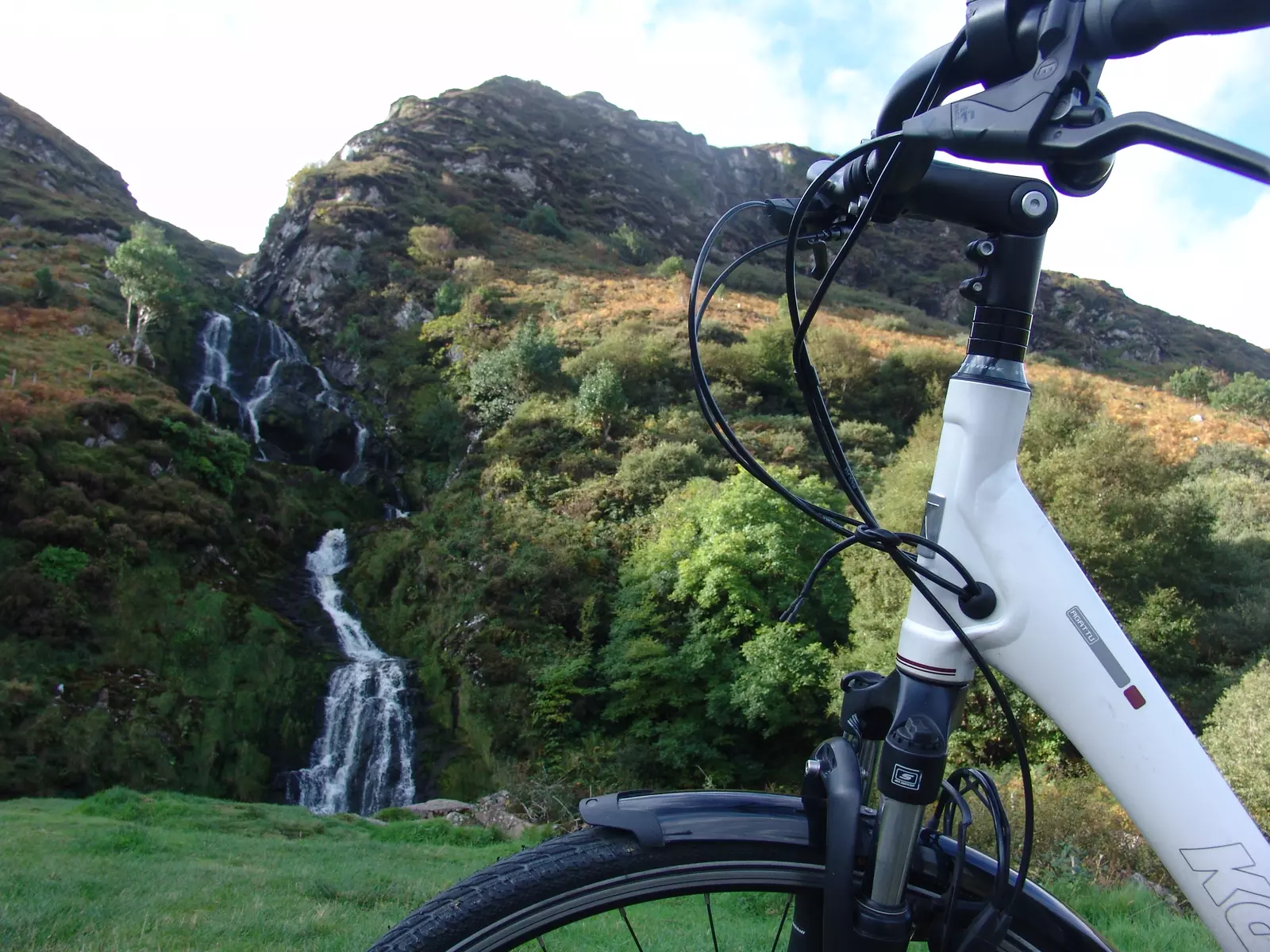 Bicycle standing in front of waterfall.