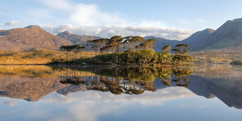 Lake with reflection of sky and mountains.